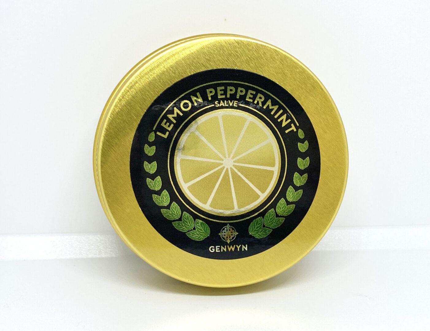 A yellow tin with lemon and peppermint on it.