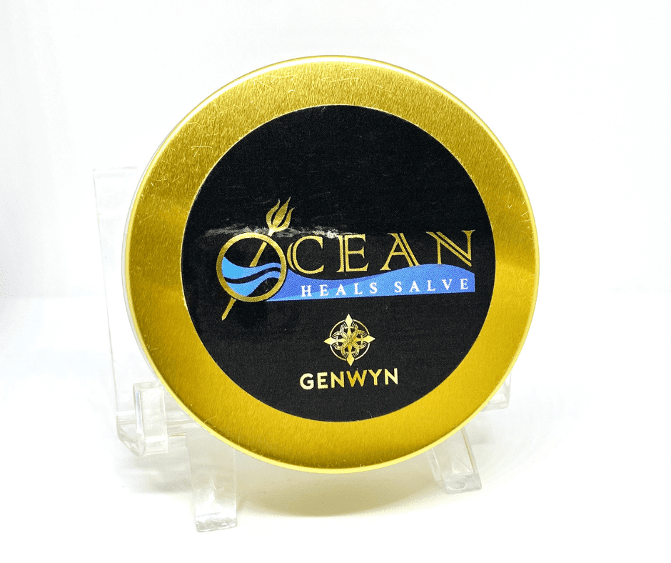 A gold and black tin of ocean brand salve.