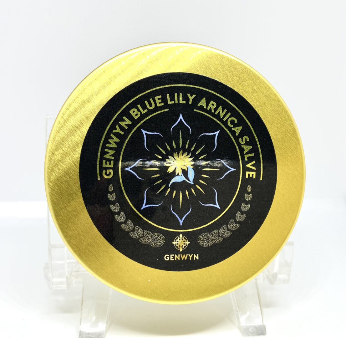 A gold frisbee with a black and yellow design on it.