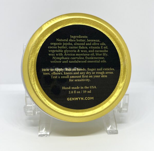 A gold tin of black honey on top of a stand.