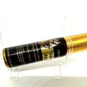 A gold tube of liquid sitting on top of a table.