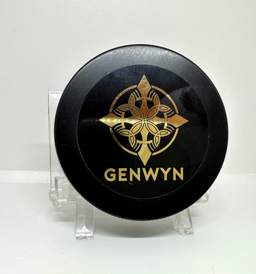 A black frisbee with gold lettering on it.