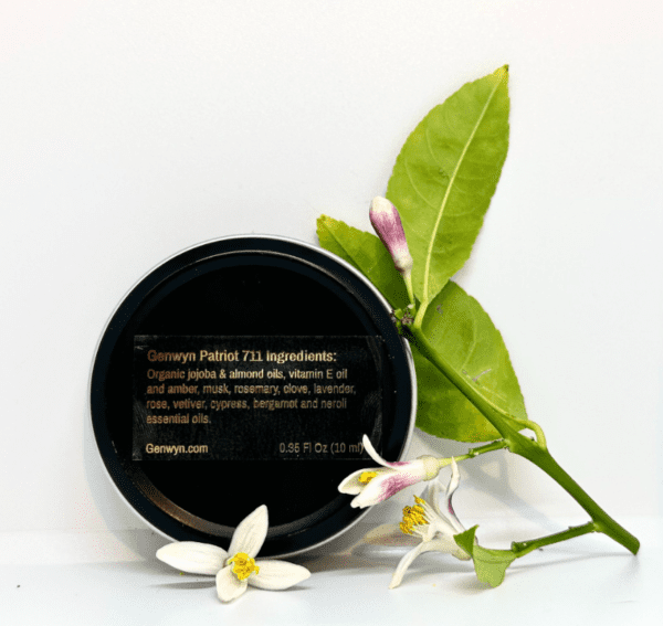 A black container with some white flowers and green leaves